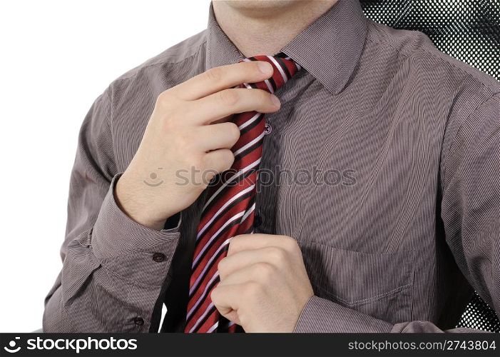 picture of a businessman adjusting his tie. Isolated on white background