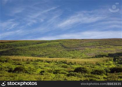 picture of a hill with clouds and blue sky, picture of a hill with blue sky in the background