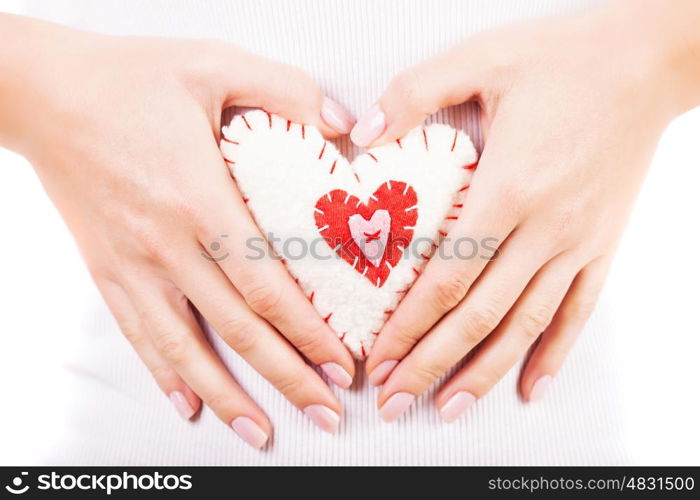 Picture of a small white heart in hands, female holds handmade sewn soft toy, macro, shallow dof, woman with Valentine gift, happy girl smiling, conceptual image of health care or love