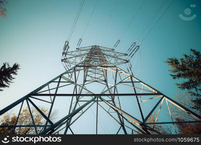 Picture of an electrical tower or pylon, blue sky in the background. Power grid or smart grid.