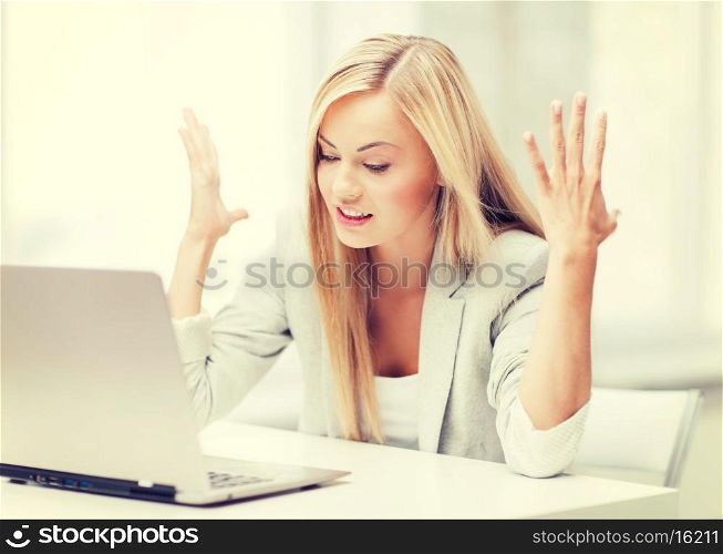 picture of angry businesswoman with laptop at work