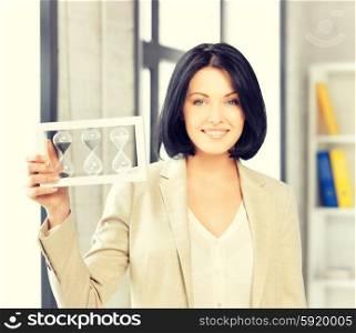 picture of attractive businesswoman holding hourglass.. businesswoman holding hourglass
