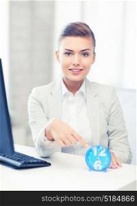 picture of attractive businesswoman pointing at clock. attractive businesswoman pointing at clock