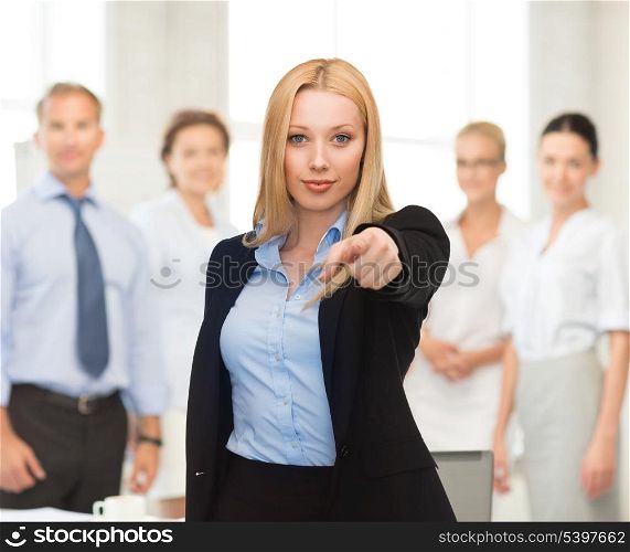 picture of attractive businesswoman pointing her finger at you