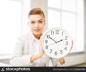 picture of attractive businesswoman showing white clock