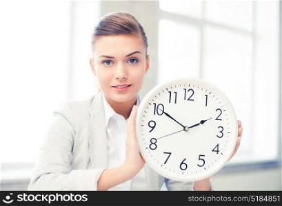 picture of attractive businesswoman showing white clock. attractive businesswoman showing white clock
