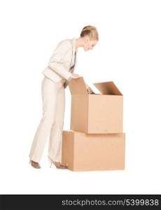 picture of attractive businesswoman unpacking big boxes