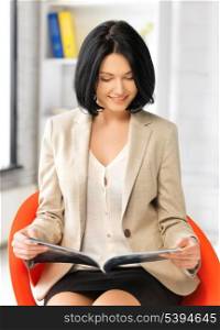 picture of attractive businesswoman with magazine.