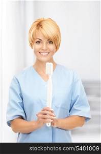 picture of attractive female doctor with toothbrush.