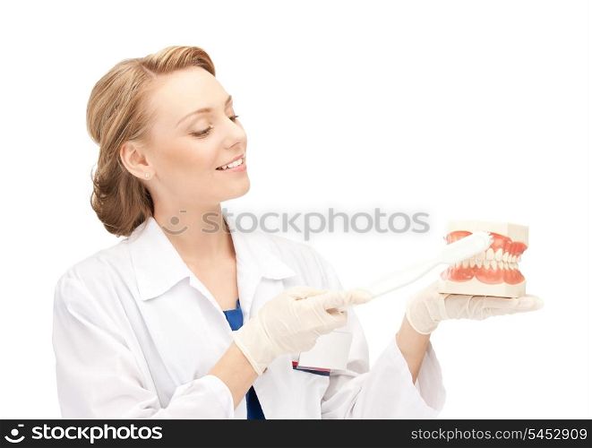 picture of attractive female doctor with toothbrush and jaws..