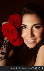 Picture of attractive female with beautiful red roses isolated on black background, sexy arabic girl with cute romantic gift, Valentines day, perfect makeup, glamorous woman, elegance concept