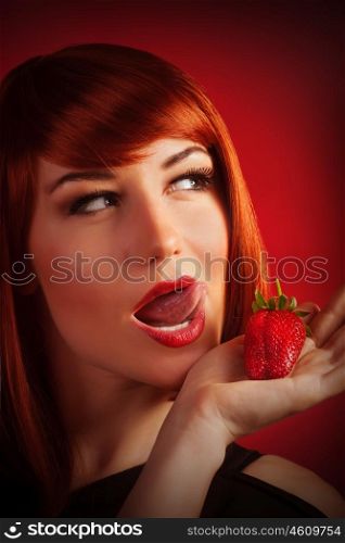 Picture of attractive female with open mouth isolated on red background, sexy red hair woman eating fresh strawberry, healthy lifestyle, fruity diet, Valentine day, pleasure and enjoying concept