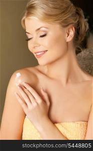 picture of attractive woman applying skin creme