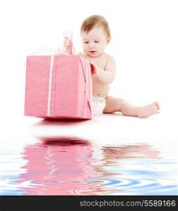 picture of baby boy in diaper with big gift box