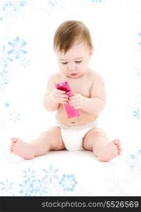 picture of baby boy in diaper with pink cell phone