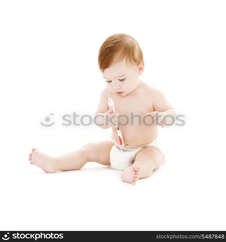 picture of baby boy in diaper with toothbrush