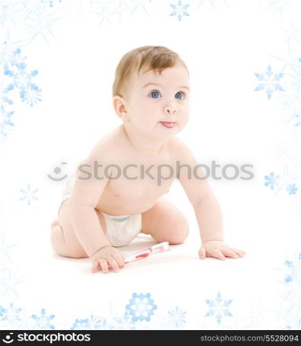 picture of baby boy in diaper with toothbrush sticking tongue out
