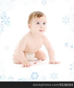 picture of baby boy in diaper with toothbrush sticking tongue out