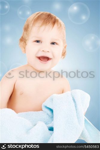 picture of baby boy with blue towel and soap bubbles