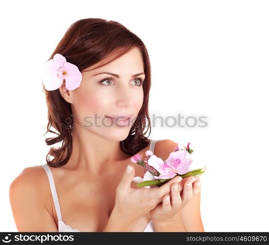 Picture of beautiful female wearing brassiere and holding in hands fresh orchid flower, closeup portrait of lovely woman with black hair, spa salon, beauty treatment, health care, purity concept