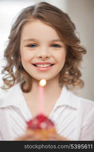 picture of beautiful pre-teen girl with cupcake