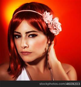 Picture of beautiful redhead woman with stylish seductive makeup isolated on red background, sexy woman wearing glamorous pink accessories on hairstyle, Valentine day, beauty and passion concept