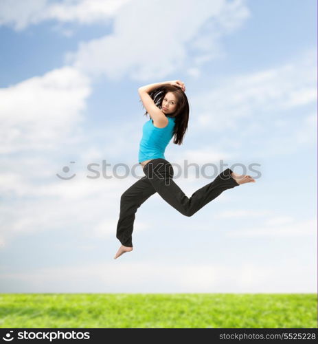 picture of beautiful sporty woman jumping in sportswear