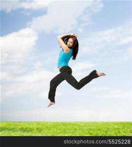 picture of beautiful sporty woman jumping in sportswear