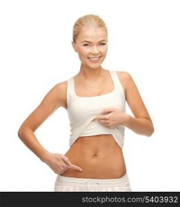 picture of beautiful sporty woman pointing at her abs