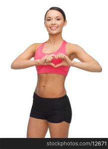 picture of beautiful sporty woman showing heart shape