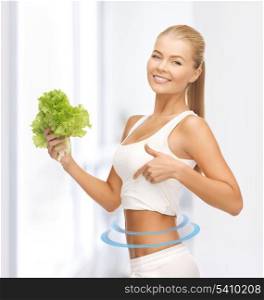 picture of beautiful sporty woman with lettuce showing abs
