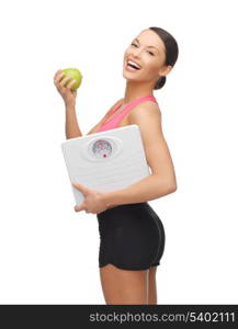 picture of beautiful sporty woman with scale and green apple