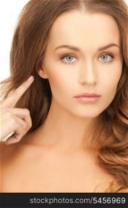 picture of beautiful woman pointing to ear