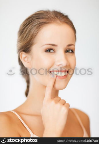 picture of beautiful woman pointing to teeth