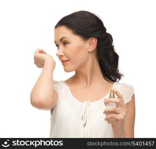 picture of beautiful woman smelling perfume on her hand