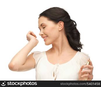 picture of beautiful woman smelling perfume on her hand