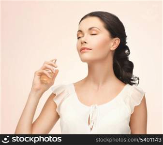 picture of beautiful woman spraying perfume on her neck