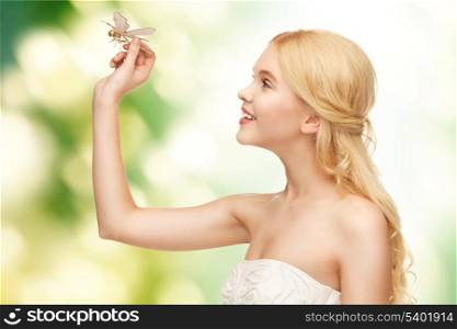 picture of beautiful woman with dragonfly in hand