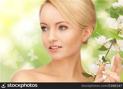 picture of beautiful woman with flowers on twig