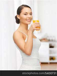 picture of beautiful woman with glass of juice at kitchen