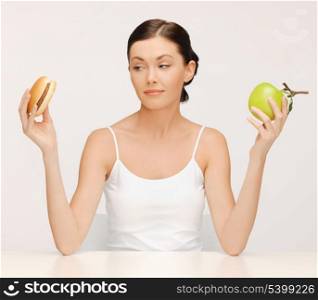 picture of beautiful woman with hamburger and apple