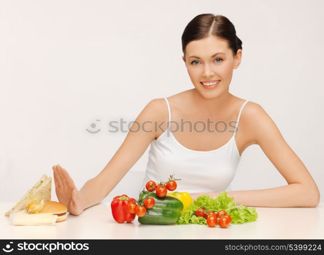 picture of beautiful woman with hamburger and vegetables