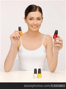 picture of beautiful woman with nail polish bottles