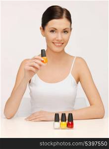 picture of beautiful woman with nail polish bottles