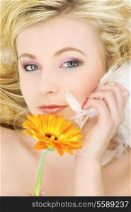 picture of blonde girl with flower and feathers