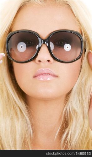 picture of blonde in big shades over white