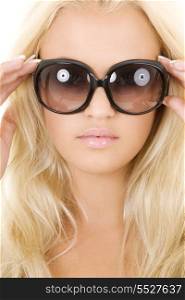 picture of blonde in big sunglasses over white
