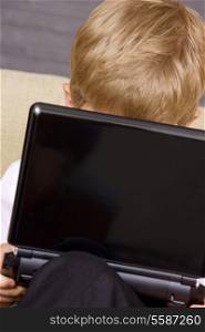 picture of boy with black laptop computer