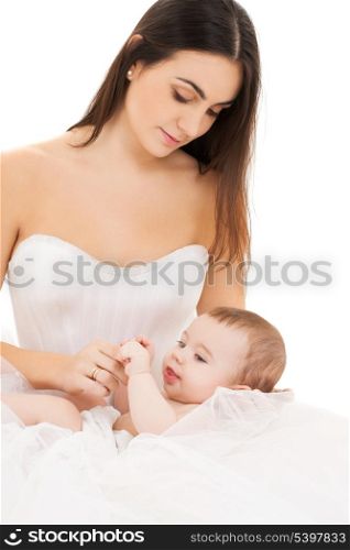 picture of bride in white dress with little baby