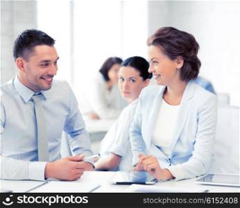 picture of business colleagues talking in office. usiness colleagues talking in office